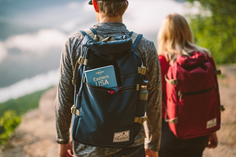 Reisende, die mit Tagesrucksack unterwegs sind